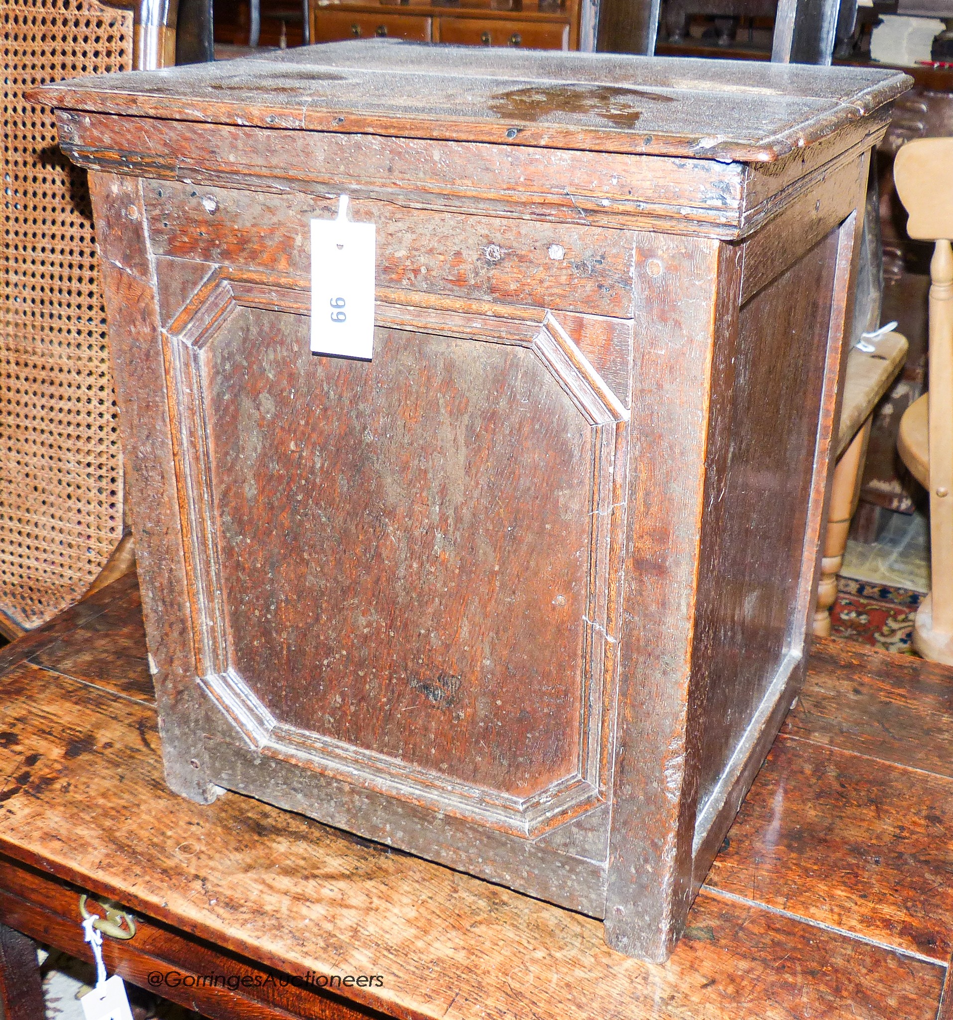 An 18th century oak cupboard of small proportions with rectangular hinged lid, width 43cm, depth 37cm, height 49cm